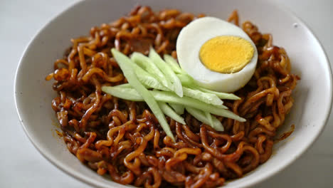 korean instant noodle with black bean sauce topped cucumber and boiled egg - korean food style