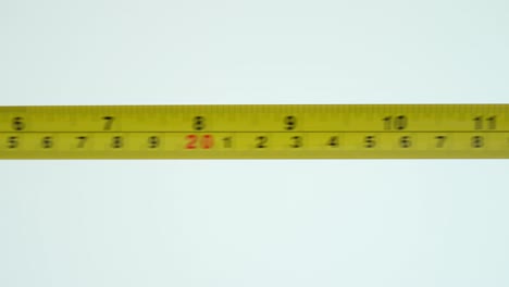 Male-hand-using-a-tape-measure-to-measure-things