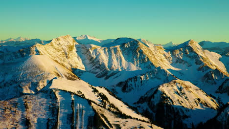 vanil noir snowy summit at sunset in canton of fribourg, switzerland - helicopter aerial