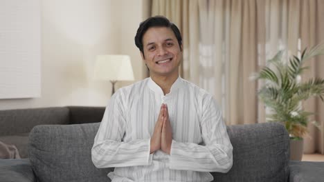 happy indian man doing namaste