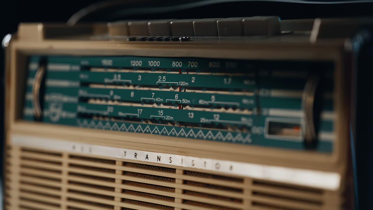 Closeup old radio panel in soft light indoors. Macro vintage FM signal receiver