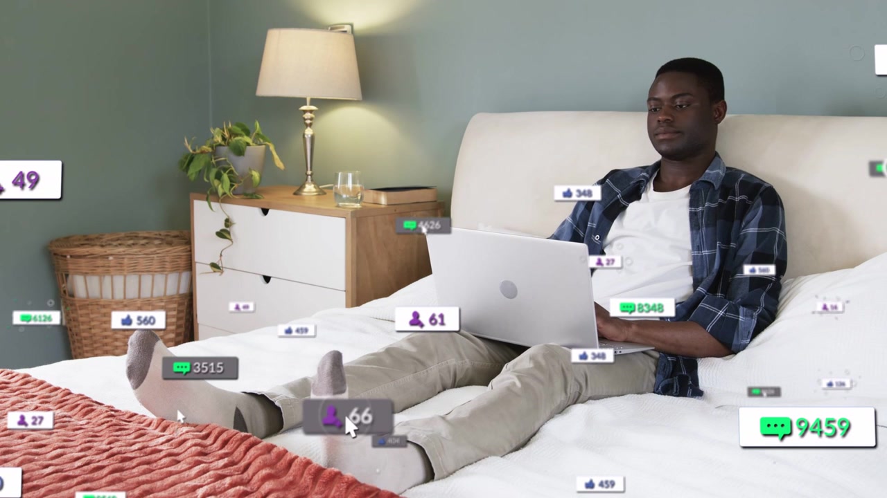 Man typing on laptop starting social likes and badges around laptop, tracking icons rising, fading