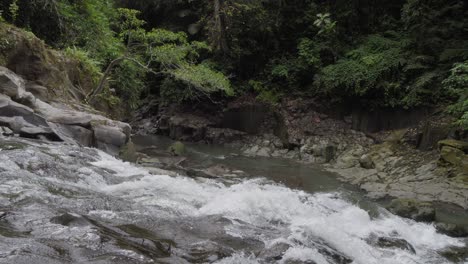 Goa-Rang-Reng-waterfall-on-Bali-island-in-Indonesia-with-small-creek-in-the-background