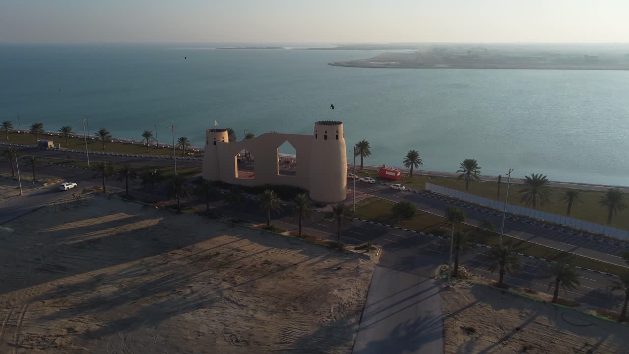 Sunset landscape with castle shaped building on Tarout Island. Aerial circling