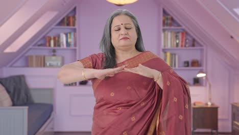happy indian old woman doing breathe in breathe out exercise