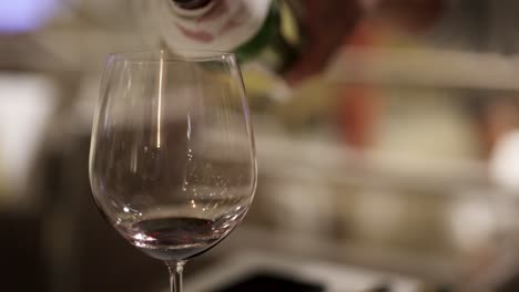 a sequence showing red wine being poured into a glass, highlighting the elegance and precision of the pour