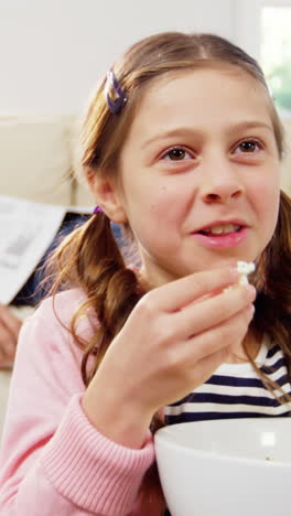 girl eating popcorn in the living room