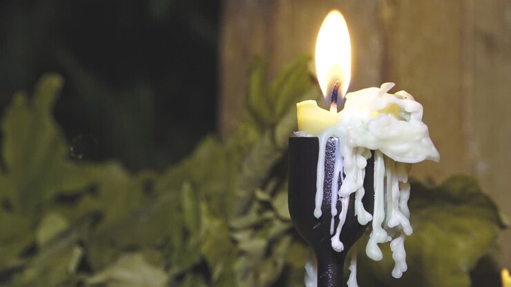 Burning candle with wax drops. Religious old candle