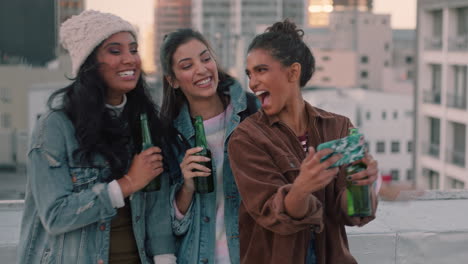 beautiful women friends taking selfie photo using smartphone enjoying rooftop party drinking alcohol sharing weekend lifestyle on social media hanging out at sunset