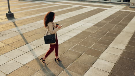 Top-view,-city-and-woman-with-a-smartphone