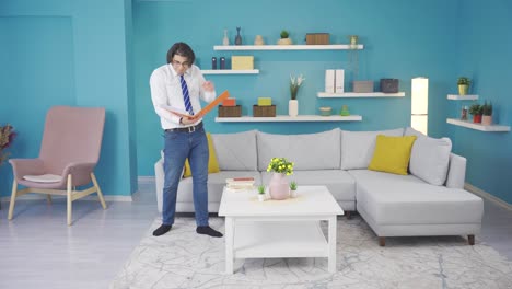 Funny-man-doing-his-job-at-home.-He-dances-and-looks-at-paperwork.