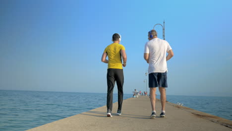 Men-exercising-by-walking-backward-along-the-pier