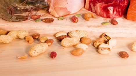 Variety of meats, nuts, and dairy products shown