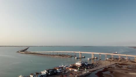 drone flyover of restaurants and marina near gulf intercoastal waterway shipping channel and jfk causeway at southern end of corpus christi bay in texas texas