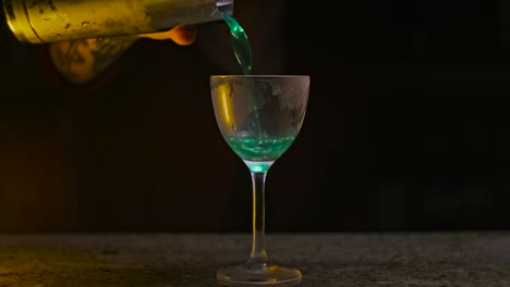 bartender pouring a cocktail