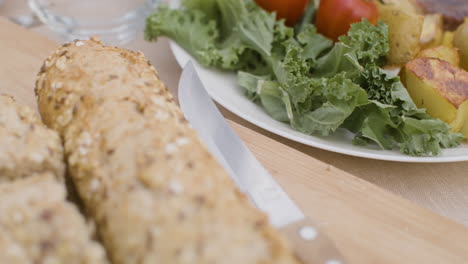 close up of a dining table with meat and bread for an outdoor party in the park