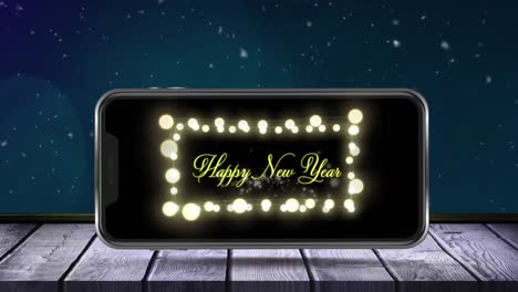 Animation-of-fireworks-exploding-and-happy-new-year-text-with-fairy-lights-displayed-on-smartphone