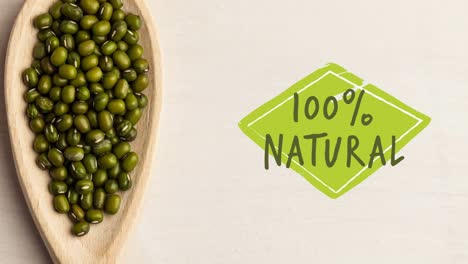 Animation-of-100-percent-natural-text-in-green-over-fresh-organic-green-sprouts-in-wooden-bowl