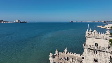 drone shot flying passed belém tower monument