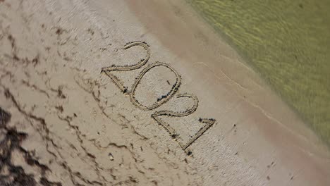 Twenty-Twenty-One-written-in-the-sand-and-spinning-counterclockwise-making-it-a-crazy-year