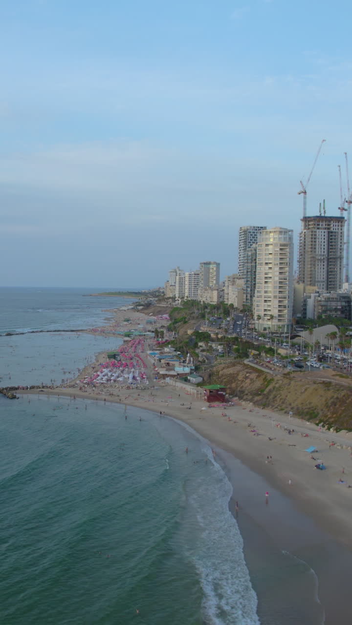 Bat Yam rock (Hasela) Beach - Vertical video - The lagoon is formed by wave breakers and most of its visitors are families with children because of the shallow water and the lack of waves