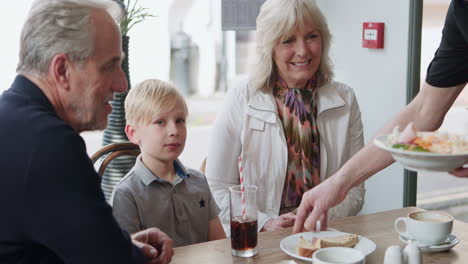 family enjoying a meal at a cafe