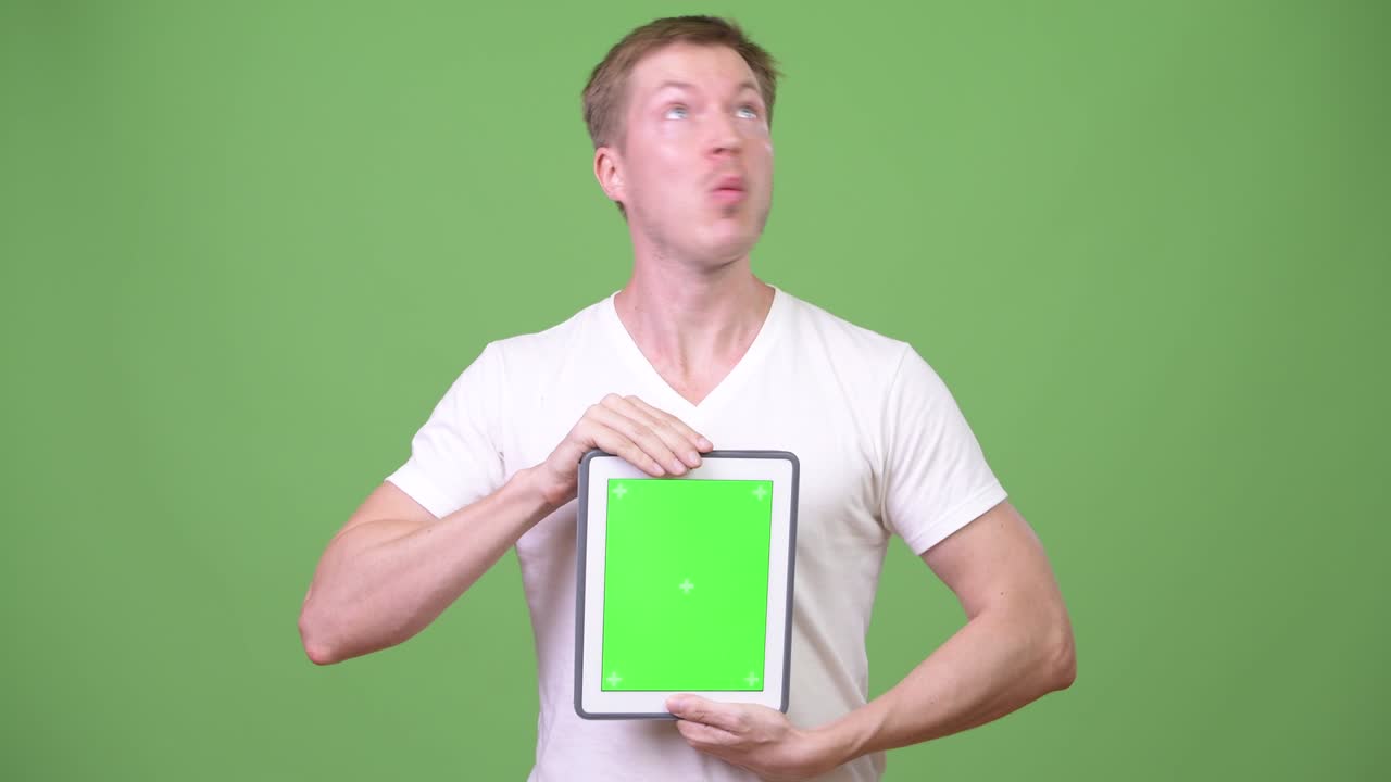 Young crazy man patient showing digital tablet