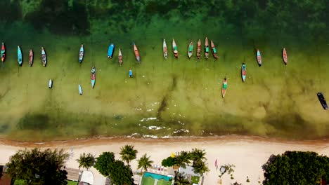 birdseye view of a longtail boat along sairee beach on ko tao island, thailand