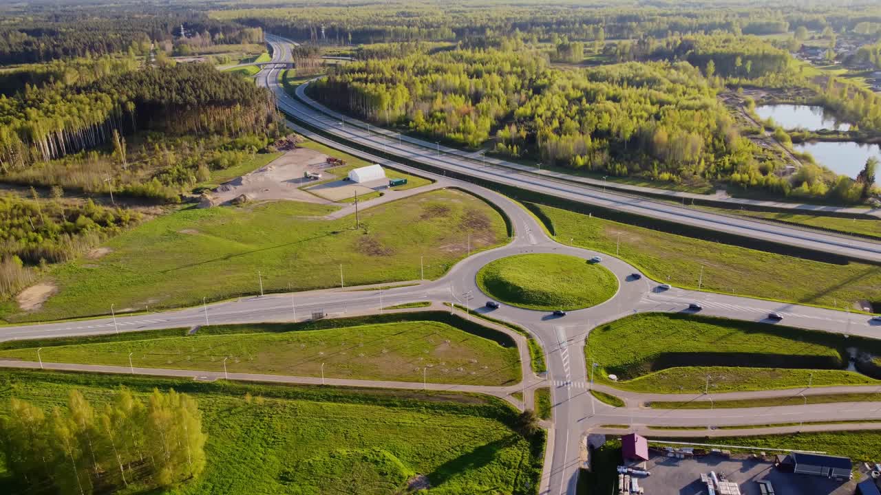 Drone footage of Katlakalns highway and roundabout showing busy traffic movement