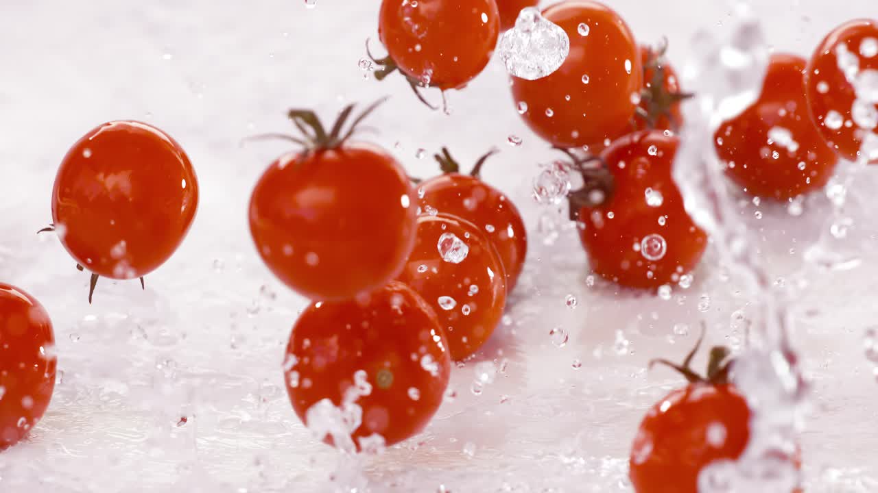 Fresh water splash on red Cherry tomatos. Shot on super slow motion camera 1000 fps