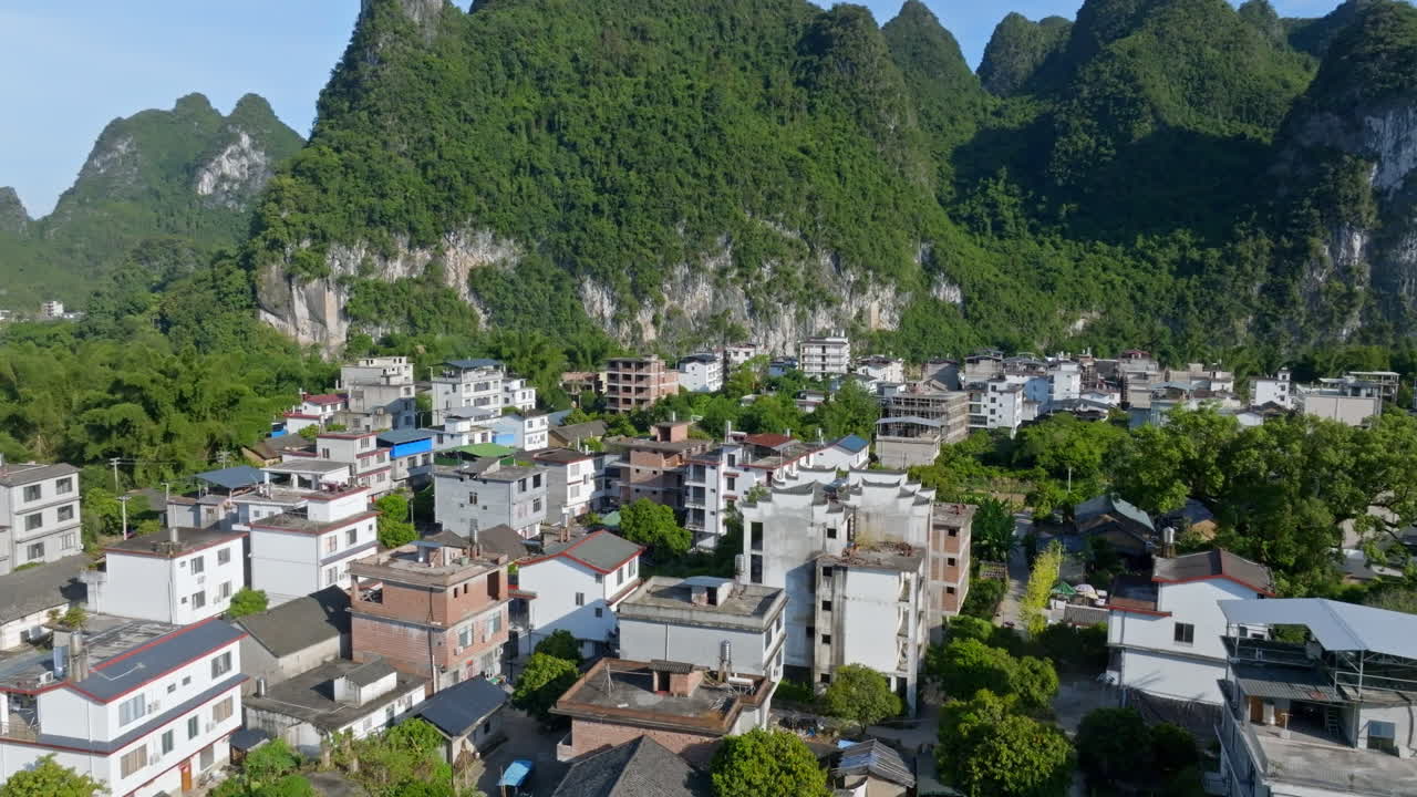 Aerial tracking shot in front of homes in the Xingping Ancient Town, in China