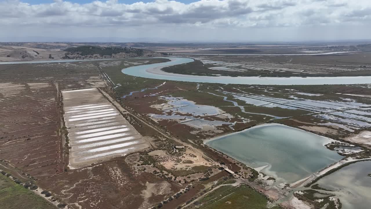 Cinematic shot of traditional salt-drying fields near the ancient Lixus site and the Loukkos River, capturing historic landscapes and natural textures in smooth motion