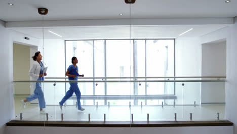 doctor and nurse running in passageway of hospital