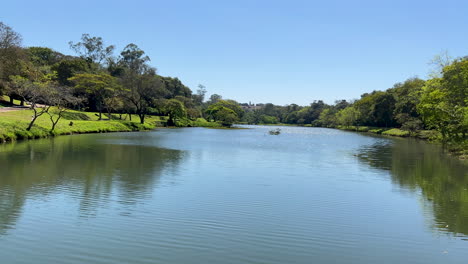 Panning-shot-of-stunning-lake-and-surrounding-greenery