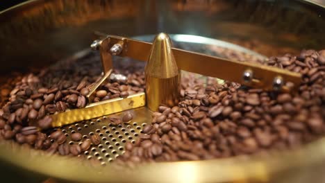 view in close up of coffee beans being cooled in a coffee toaster