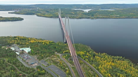 scenic vista of hogakustenbron suspension bridge in sweden with calm and autumn forest