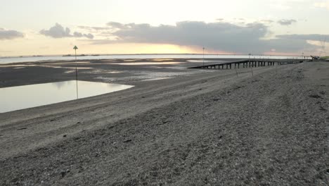 Pebble-beach-with-golden-sunset-and-sea-on-the-horizon,-Southend-on-sea