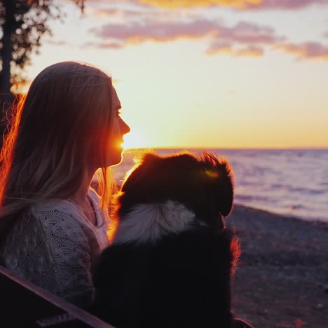 a woman rests with a dog on a bench