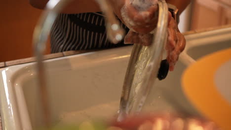 scrubbing the dishes clean after a family meal - slow motion