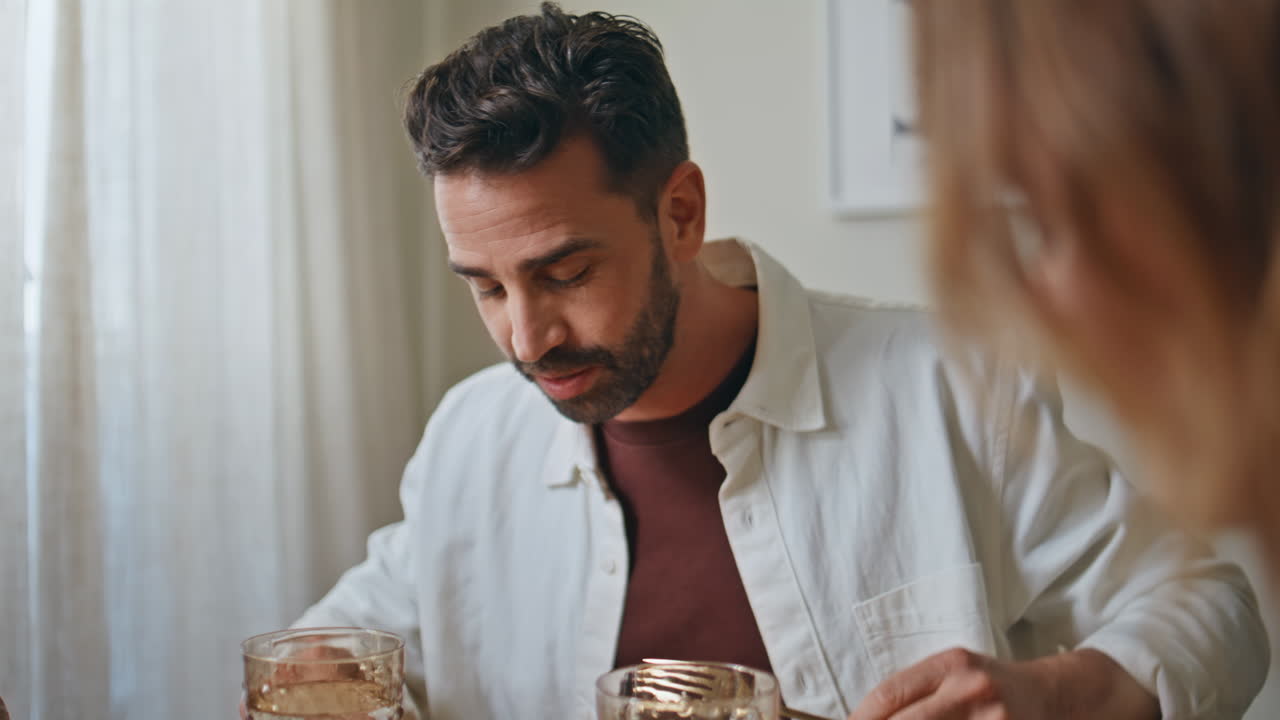 Hungry guy talking wife at light modern kitchen closeup. Bearded man speaking