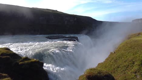 aerial shot of huge waterfall in iceland during the sunny time