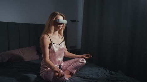 woman meditating in bed with vr headset