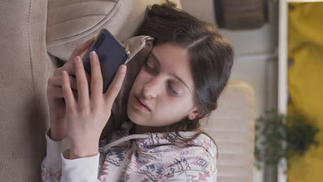 Vertical-video-of-Phone-addicted-young-woman-at-home-at-night.