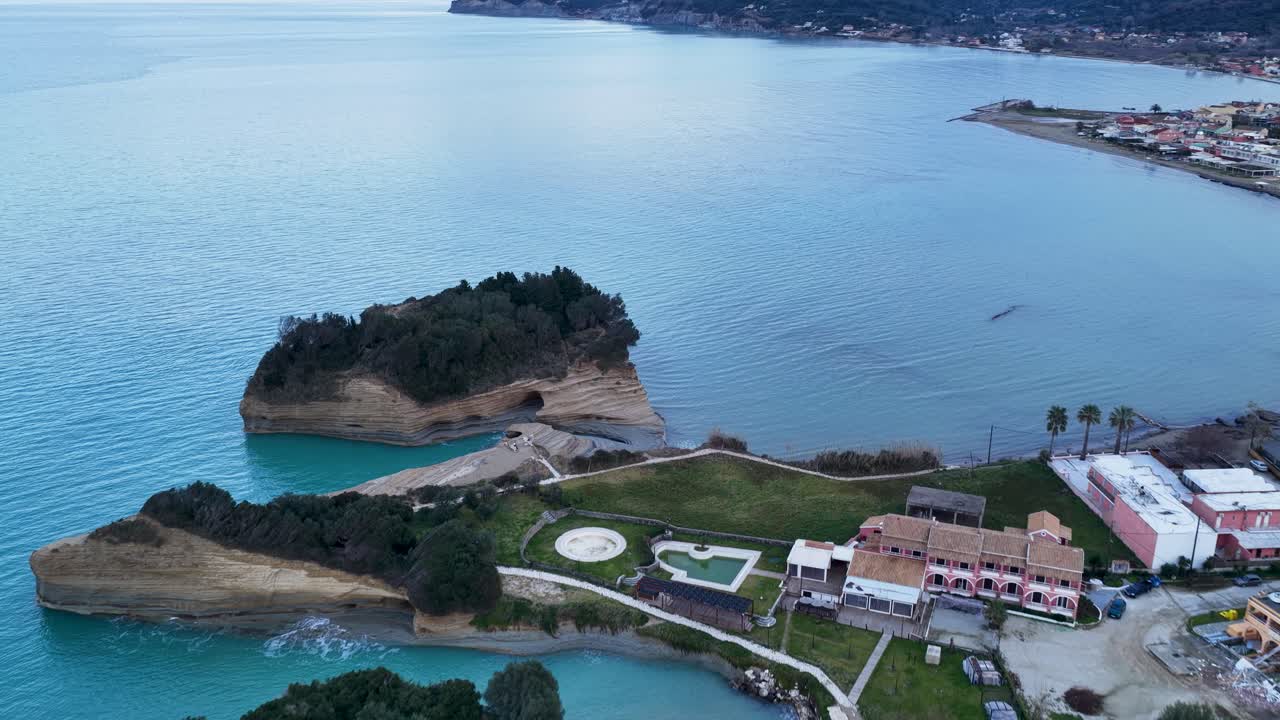 Aerial view of the famous Canal d'Amour rock formations and coastline in Sidari, Corfu Island, Greece, featuring unique sandstone cliffs, turquoise Ionian Sea waters, coastal resorts