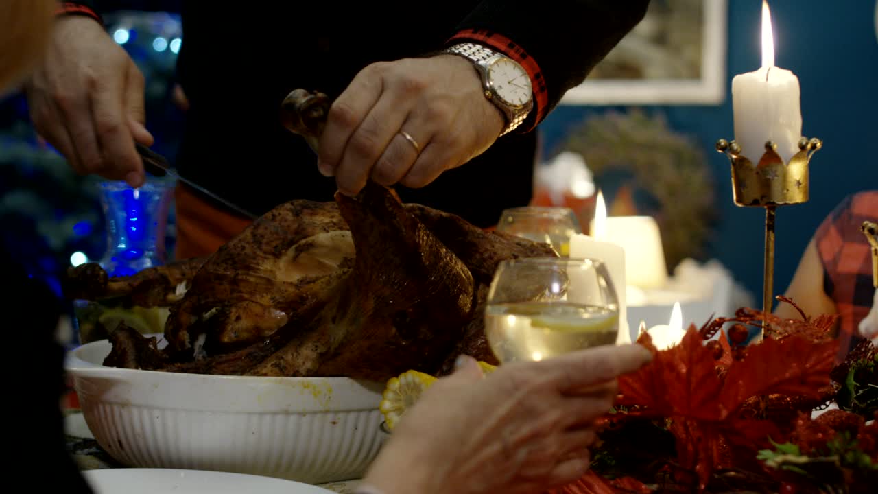 Man carving turkey on Christmas dinner