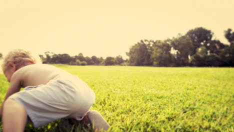 cute baby boy running in grass field