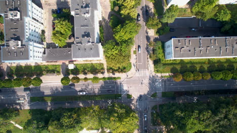 Summer-Car-Traffic-on-Crossroad-in-Residential-District-by-Park-Centralny-in-Gdynia-City---aerial-top-down-flying