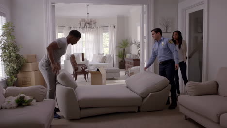 people moving a sofa into a new home