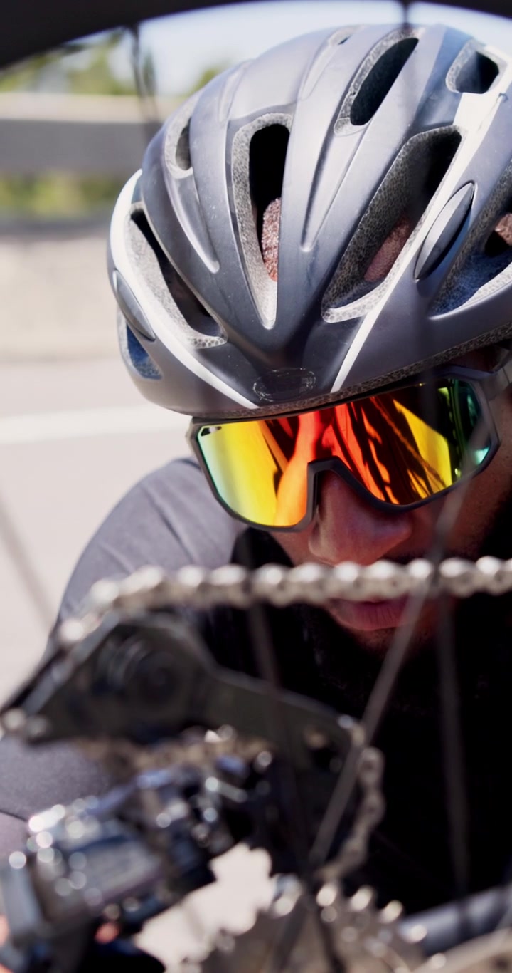 Cyclist Inspecting Bicycle Drivetrain and Chain