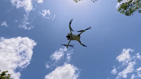 drone ascends into clear blue sky